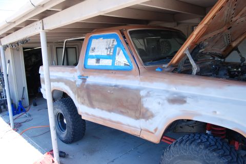 1982 Ford Bronco - This SUV is undergoing bodywork and painting, with its hood open and windows taped off.
