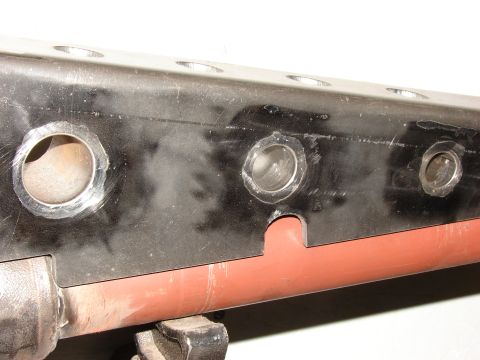 1996 Jeep Grand Cherokee - This image shows a close-up of a vehicle's frame, multiple drilled holes and a red-painted tube.