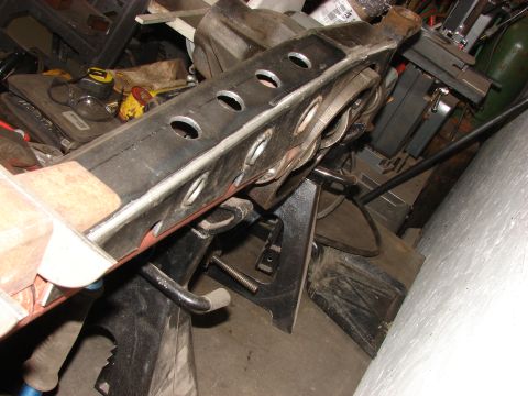 1996 Jeep Grand Cherokee - A close-up view of a vehicle suspension component supported by jack stands in a workshop setting.