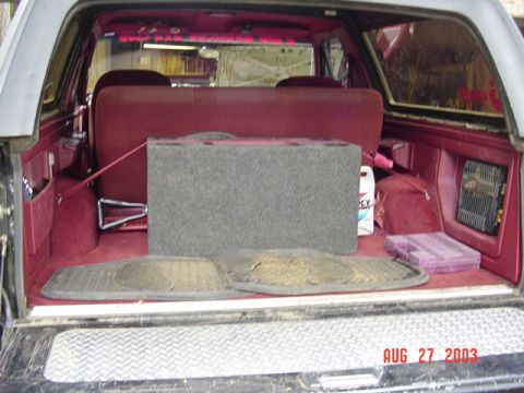 1989 Ford Bronco - Interior setup, with speaker box, hi-lift, 4-way, air hose (for OBA), tow strap, shovel, tool box, and a gallon of water.