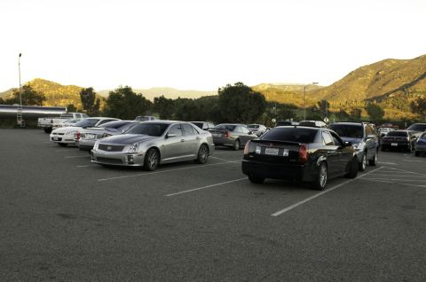 2006 Cadillac STS - A silver 2006 Cadillac STS is parked in a lot with other vehicles under a bright sky.