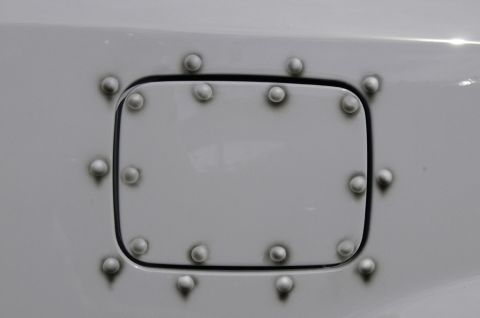2006 Cadillac STS - A close-up of a vehicle's fuel door, decorated with a pattern of rivets.