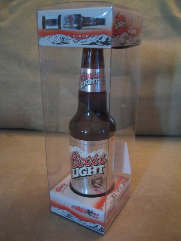 Coors Light beer bottle inside clear plastic packaging with mountain graphics