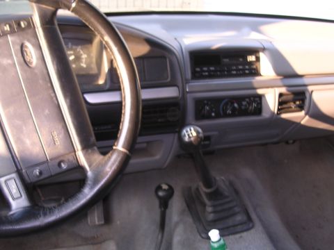 1995 Ford Bronco - The interior of a 1995 Ford Bronco, captured from the driver's perspective.