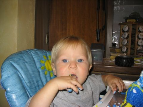 1986 Ford Bronco - Toddler enjoys cake at a birthday party, with a sun-patterned high chair.