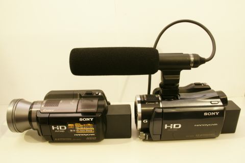 1993 Ford Taurus - Two Sony Handycam camcorders are shown side-by-side, one equipped with an external microphone.