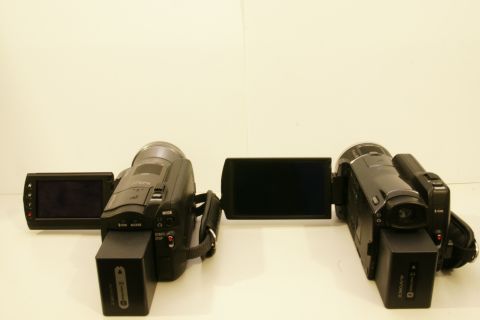 1993 Ford Taurus - Two camcorders are displayed side-by-side, each with its screen and battery pack visible.