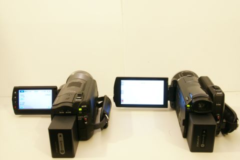 1993 Ford Taurus - Two camcorders are displayed side-by-side, each with its screen open. One screen shows text, while the other is blank.