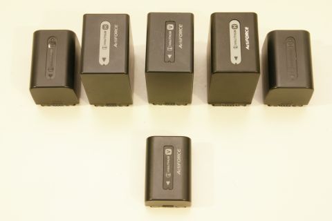 1993 Ford Taurus - A collection of rechargeable camera batteries, some larger than others, are displayed against a neutral background.