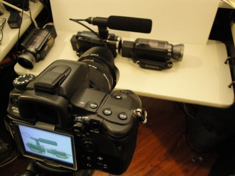1993 Ford Taurus - A DSLR camera is set up to film two camcorders and a microphone on a white surface.