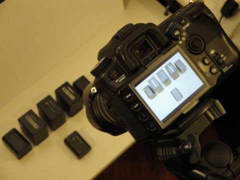 1993 Ford Taurus - A digital camera is shown with several spare batteries laid out on a surface.
