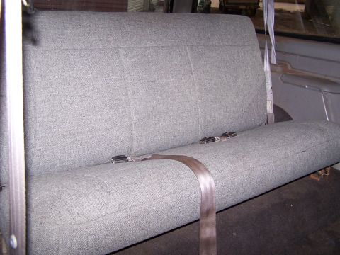 1996 Ford Bronco - Interior view of a gray fabric rear bench seat with seatbelts.