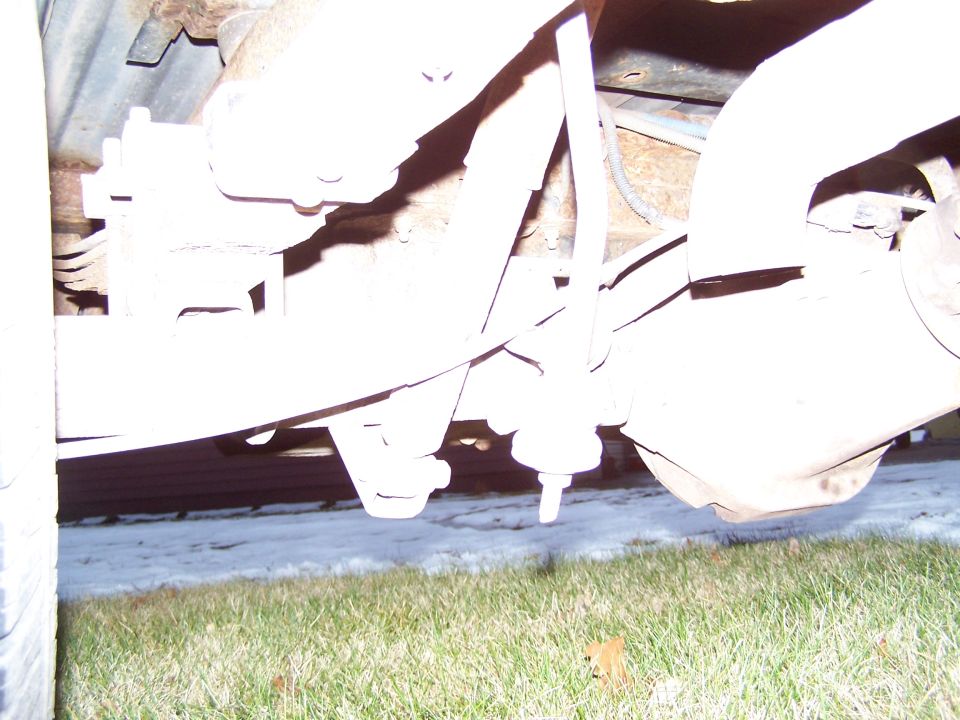 Underside view of vehicle's rear suspension and exhaust pipe