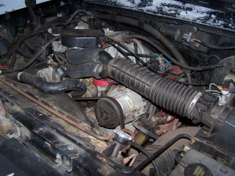 1996 Ford Bronco - A close-up view of a vehicle's engine bay, showing various mechanical parts and wiring.