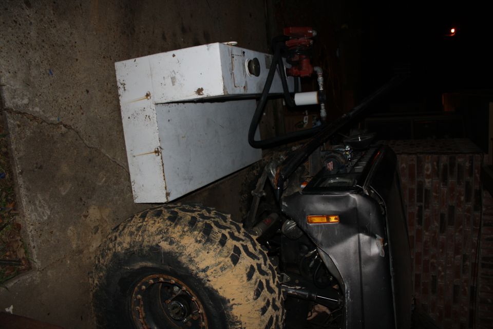 Modified off-road vehicle with large auxiliary tank and off-road tires