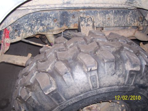 1978 Ford Bronco - Detail shot of a tire and vehicle undercarriage, dated 12/02/2010.