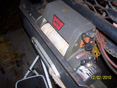 1978 Ford Bronco - Close-up of a Warn winch and its rope, mounted on a vehicle. The photo is dated 12/02/2010.