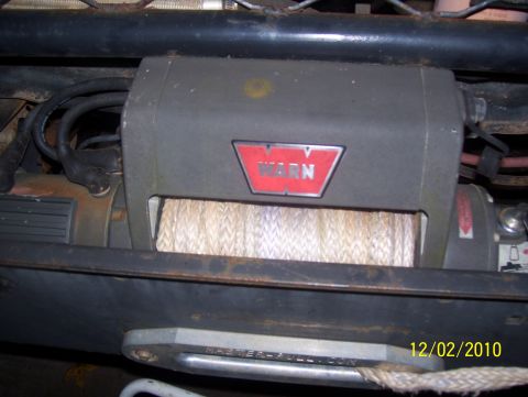 1978 Ford Bronco - Close-up of a Warn winch with a date stamp of 12/02/2010 visible.