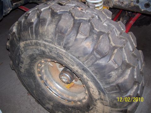 1978 Ford Bronco - Close-up view of a large off-road tire and suspension components, with a date stamp of 12/02/2010.