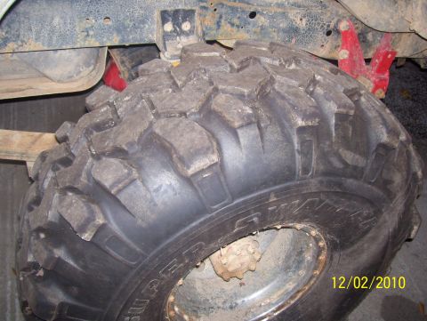 1978 Ford Bronco - Close-up of an off-road tire and suspension parts, not a full vehicle.