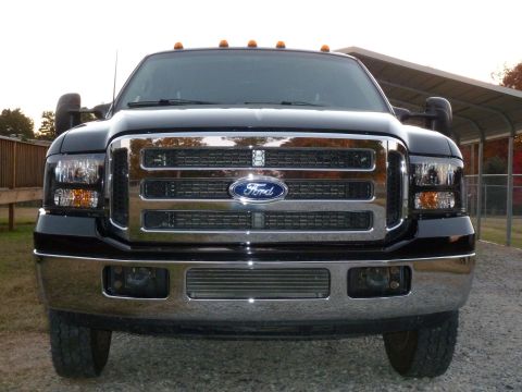1992 Ford Mustang - Front view of a black Ford F-Series truck with a chrome grille and amber marker lights.
