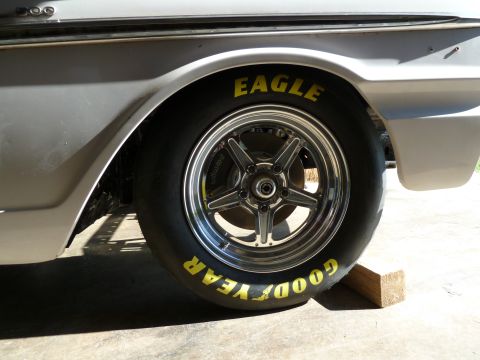 1992 Ford Mustang - Close-up of a classic car's rear wheel and fender, showing Goodyear Eagle tires and a chrome wheel.