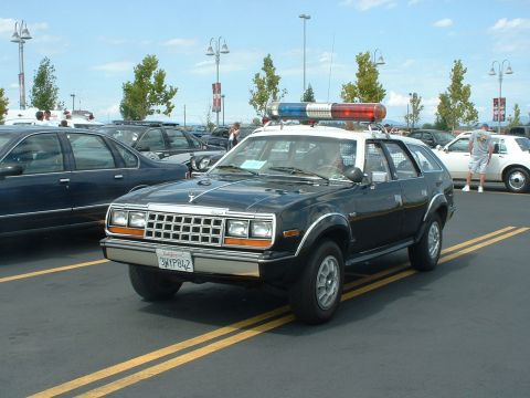 1999 Ford Crown Victoria - This police car, possibly an AMC, is parked at a show with other vehicles.