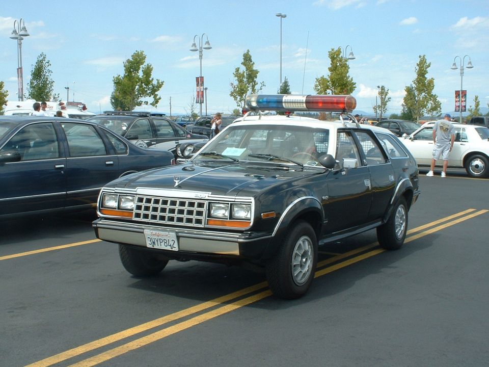 Black and white police car with light bar and California plates
