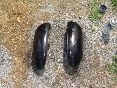 1999 Ford Taurus - Two car side mirrors are on the ground next to a can of spray paint.