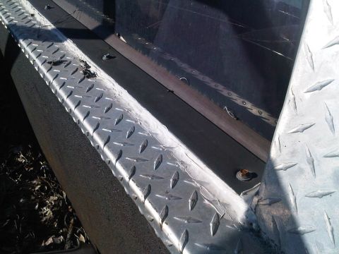 1992 Ford Bronco - Close-up view of diamond plate trim on a vehicle, likely a truck bed or SUV rear.
