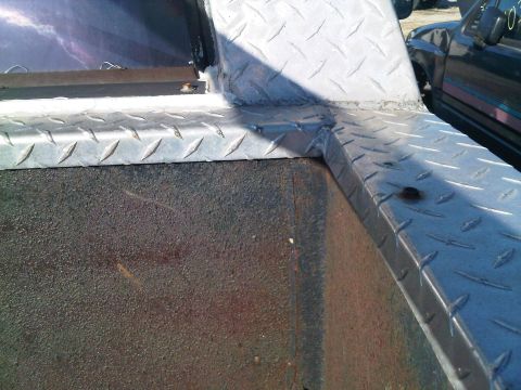 1992 Ford Bronco - Diamond plate bed liner and corner detail on a truck, with another vehicle in the background.
