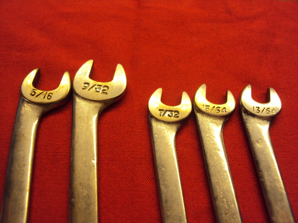 Five wrenches with fractional inch sizes stamped on them: 5/16, 9/32, 7/32, 13/64, and 13/64