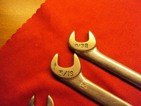 1965 Ford Mustang - Close-up of two wrenches with fractional inch sizes marked on them.