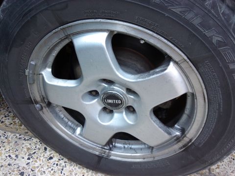 1998 Ford Crown Victoria - A close-up view of a vehicle's wheel and tire, showing the 'LIMITED' branding on the center cap.