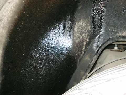 1998 Ford Crown Victoria - Close-up of underbody coating, likely showing an area of concern for leaks.