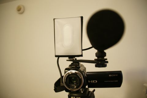 1993 Ford Taurus - A Sony Handycam is set up with a microphone and a small LED light, ready for recording.