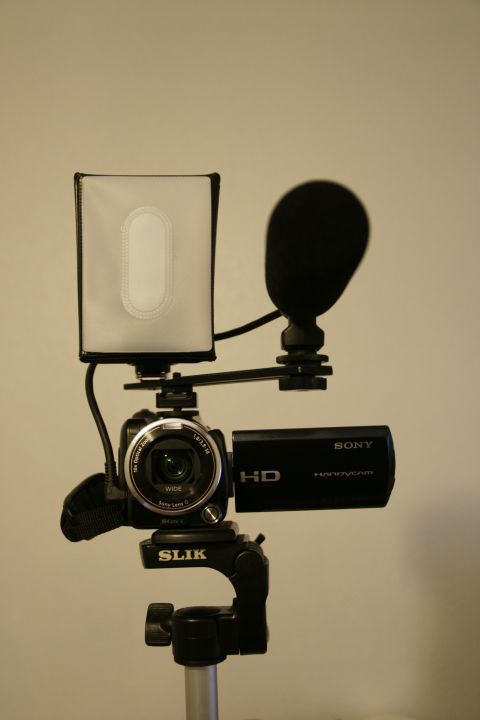 1993 Ford Taurus - A Sony Handycam is shown mounted on a tripod clamp with a microphone and LED light attached.