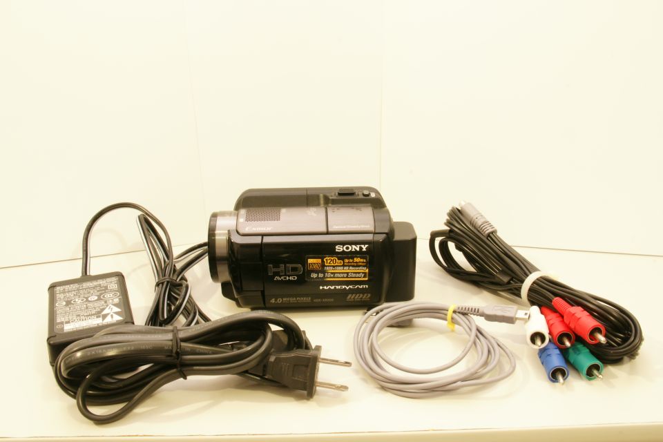 Black Sony Handycam HDR-XR500V with cables and AC adapter