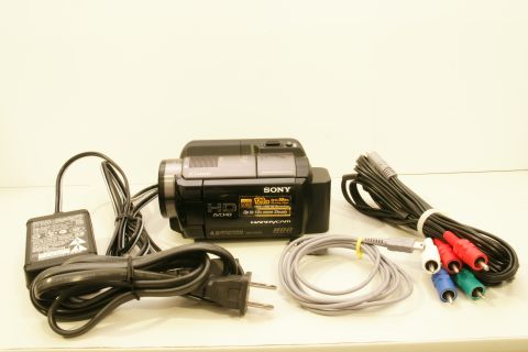 1993 Ford Taurus - A Sony Handycam HDR-UX10 camcorder is shown with its power adapter and various cables.