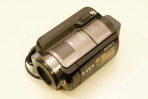 1993 Ford Taurus - A close-up view of a black Sony Handycam camcorder, highlighting its 'Exmor HD' and 'GPS' features.