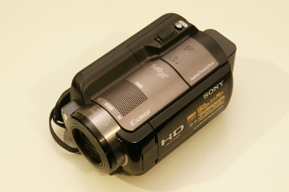 Black Sony Handycam HDR-CX110 camcorder with lens and strap