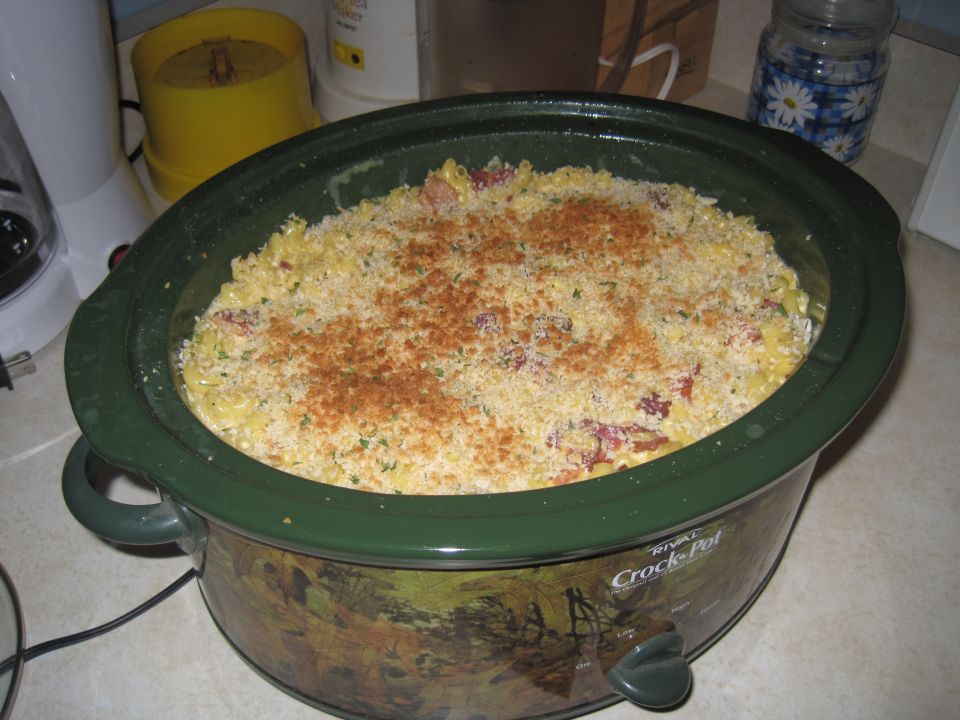 Crock-Pot slow cooker filled with pasta casserole topped with breadcrumbs and paprika