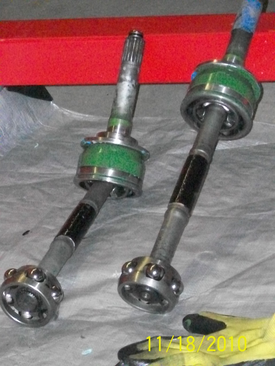Two CV axles with green boots and ball joints