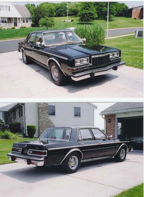 1991 Ford LTD Crown Victoria - This black sedan is parked in a suburban driveway, showing its front 3/4 profile.