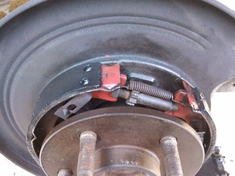 1998 Ford Crown Victoria - The image shows a close-up view of a vehicle's rear drum brake assembly, highlighting the brake shoes and springs.