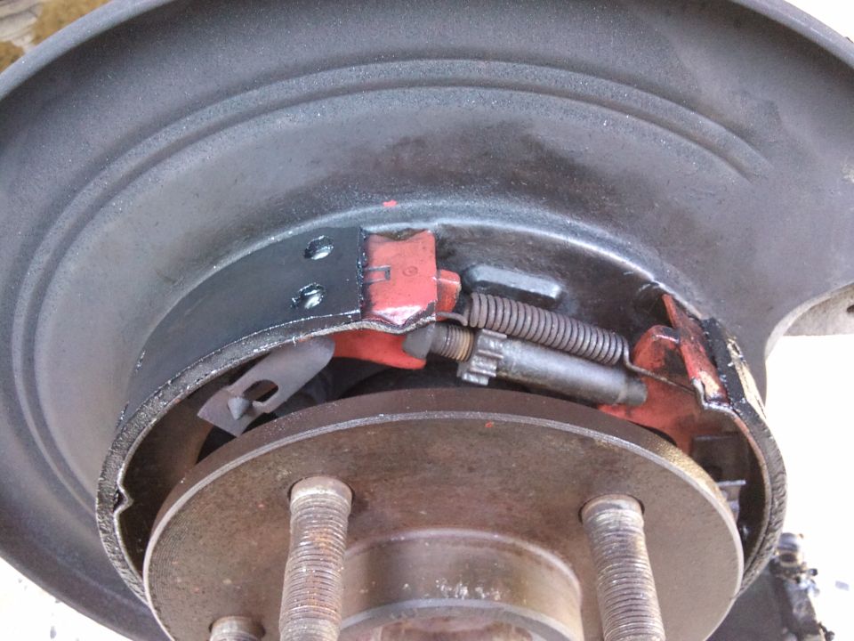 close-up of a car's rear drum brake assembly with new brake shoes and springs
