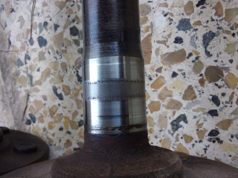 1998 Ford Crown Victoria - Close-up of a worn axle shaft, showing damage to the bearing surface.