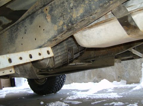 1986 Ford F-150 - Undercarriage of a 1986 Ford F-150, revealing the fuel tank and transmission components.