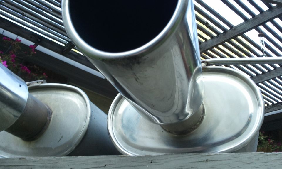 Close-up of two chrome exhaust pipes, one angled towards the camera