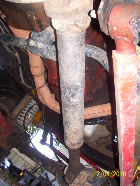 1978 Ford Bronco - Underside view of vehicle drivetrain components, showing driveshaft and U-joints.